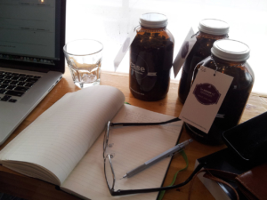 Desk filled with writing materials and coffee
